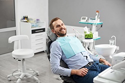Man leaning back in dental chair smiling