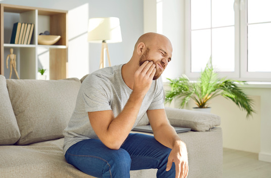 man experiencing tooth pain 